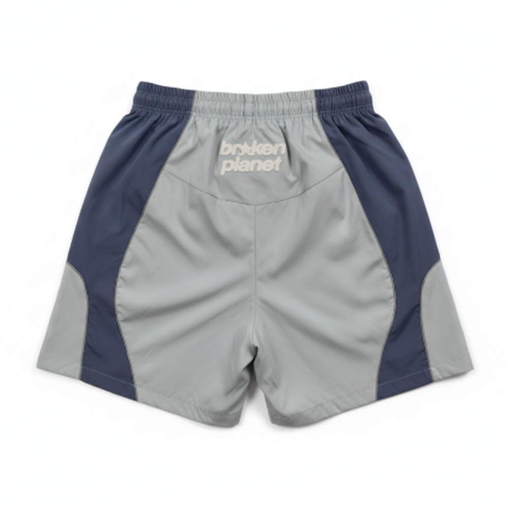BROKEN PLANET COLOR BLOCK WIND SHORTS LIGHT BLUE NAVY - back white background flat lay