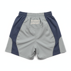 BROKEN PLANET COLOR BLOCK WIND SHORTS LIGHT BLUE NAVY - back white background flat lay